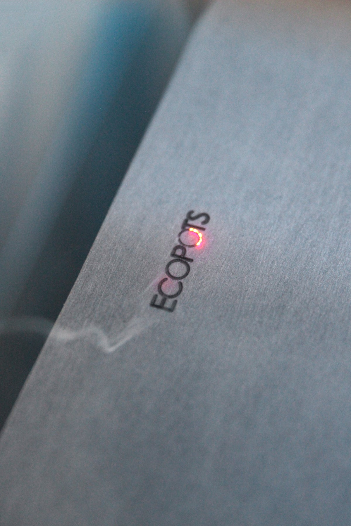 Lasergravering av Ecopots-logotypen på krukans sida